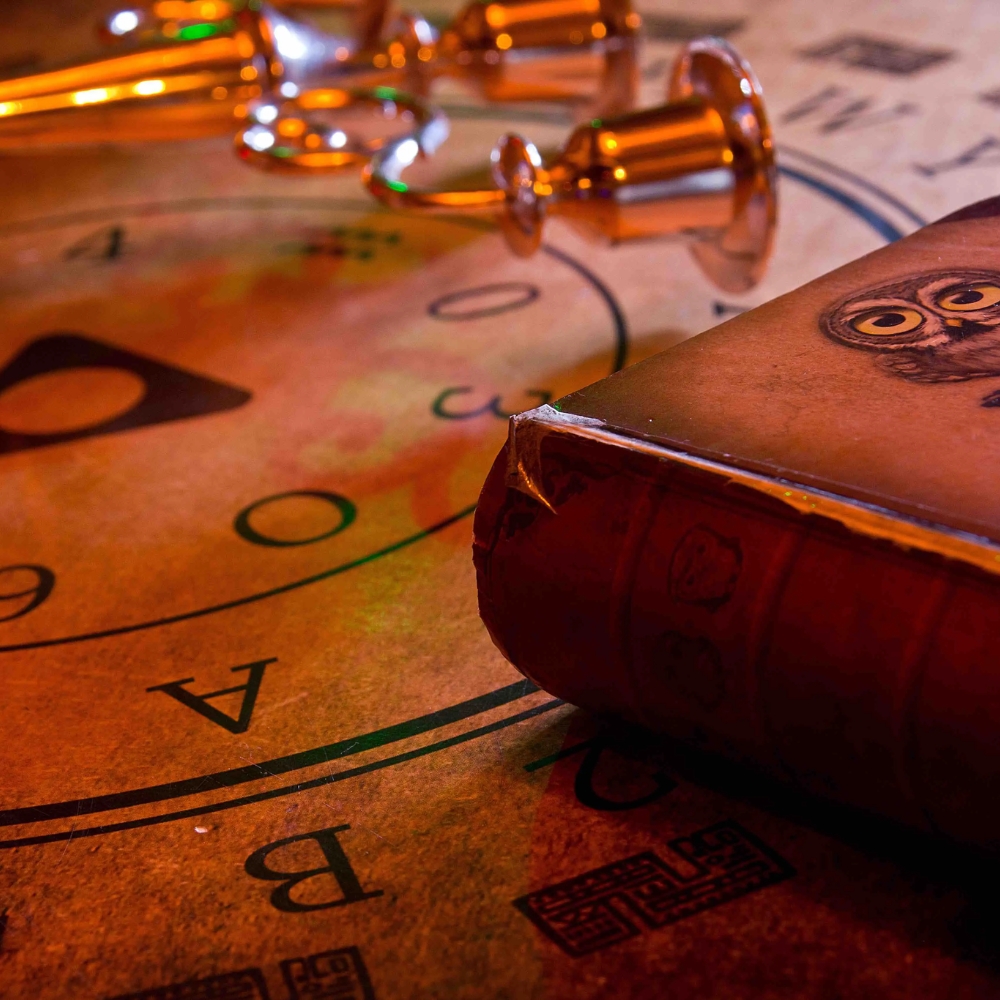 Book and candlestick placed on a table with a mysterious ambiance