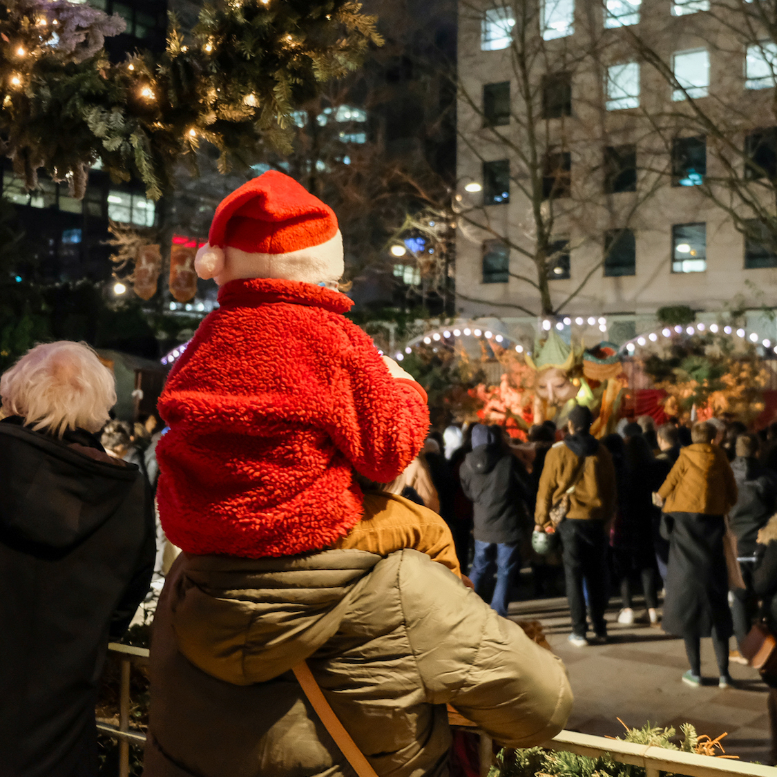 enfant-avec-un-bonnet-de-noel-sur-les-epaules-d-un